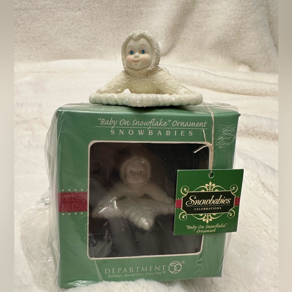 New in box Dept 56 Snowbabies   Snowbaby laying on a snowflake ornament.